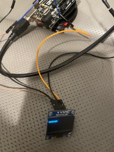 Arduino connected to OLED screen which Displays "message" (in a small font)