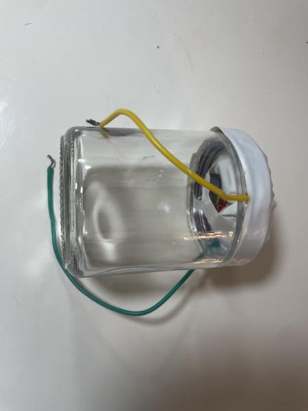 Glass Speaker with a Plastic Top connected to wires and a homemade speaker