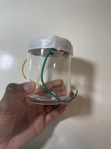 Glass Speaker with a Plastic Top connected to wires and a homemade speaker