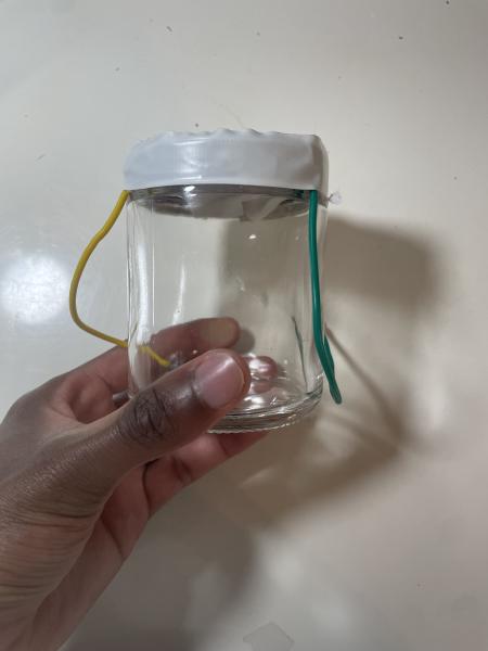 Glass Speaker with a Plastic Top connected to wires and a homemade speaker